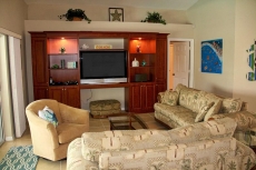 Family room has a large HDTV, Sonos system, Apple TV, Blue-Ray, & pool access.