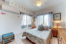 Breezy tropical Oceanfront 2-story condo with a shared pool & beach access!