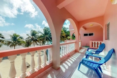 Breezy tropical Oceanfront 2-story condo with a shared pool & beach access!