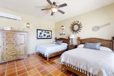 Colorful coastal retreat with sweeping ocean views, huge patio, & shared pool