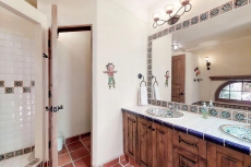 Colorful coastal retreat with sweeping ocean views, huge patio, & shared pool