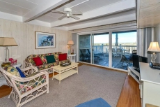 Spacious, traditional 3 bedroom oceanfront townhouse with WiFi, a large covered deck, balcony access from multiple rooms, and amazing view of ocean located uptown in family-friendly neighborhood and mere steps to beach!
